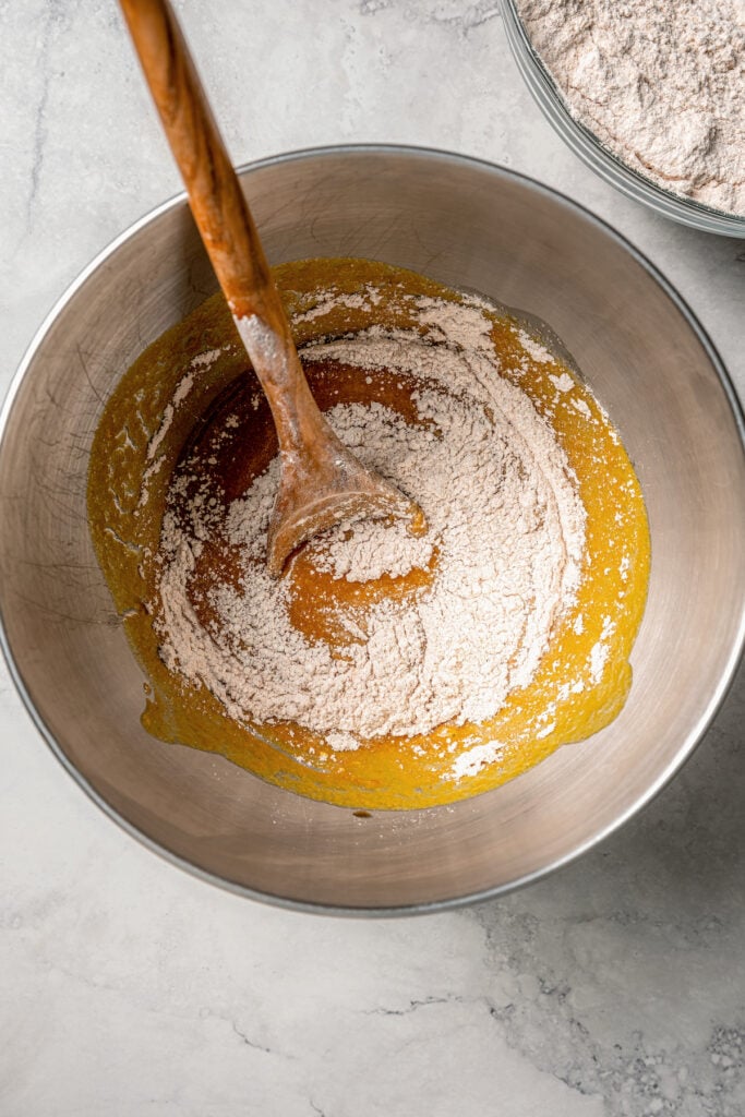 Combining the dry ingredients and wet mixture in a bowl.