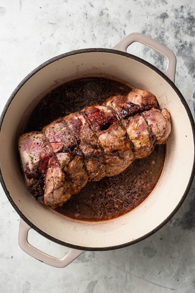 Seared pork in the Dutch oven with red wine for deglazing. 