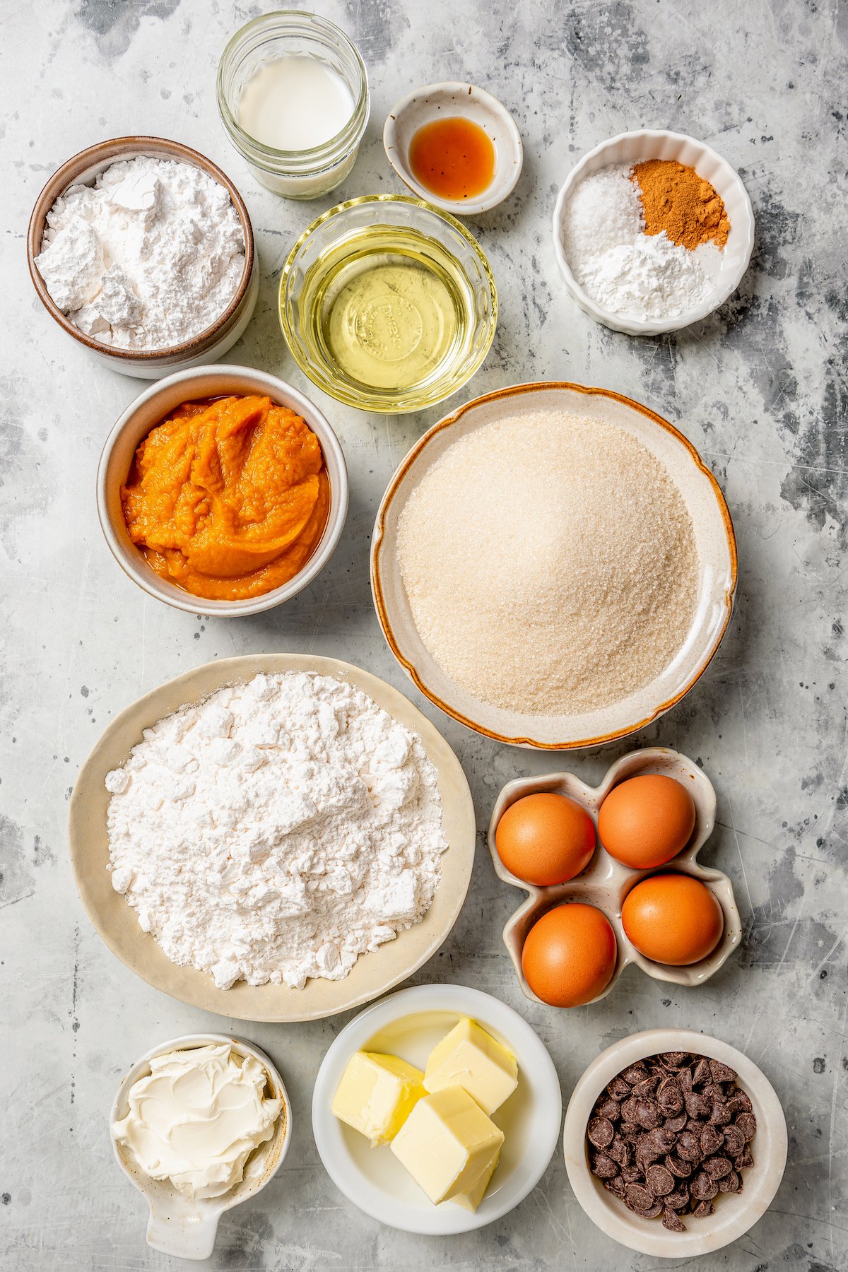 Ingredients for making homemade pumpkin cake with chocolate frosting.