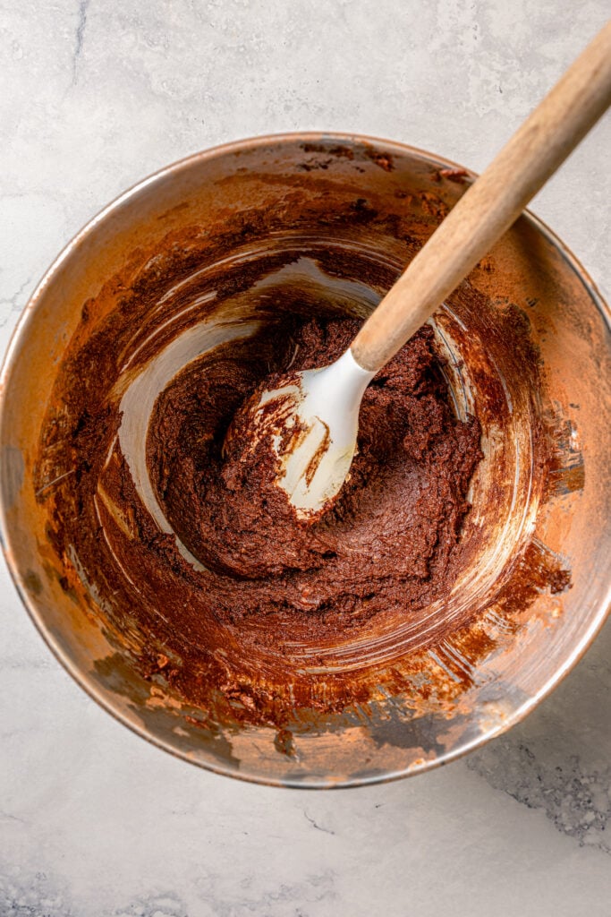 Mixing the chocolate frosting in a bowl. 